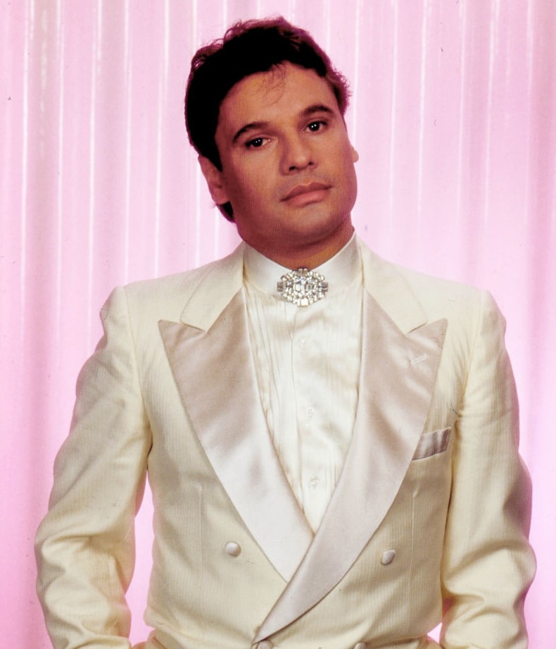 Juan Gabriel wearing a cream suit